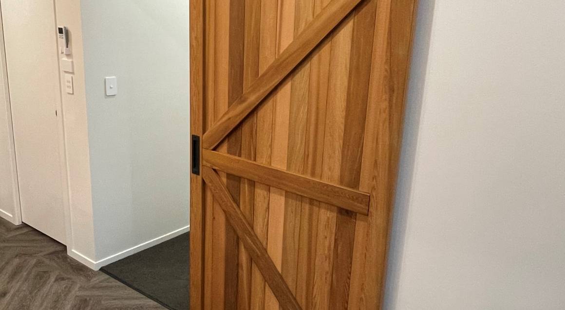 Interior barn sliding door maximizes space in 128m² Design and Build